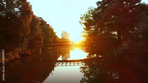 Aerial of Man Crossing a Bridge at Sunrise