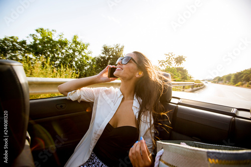 Woman uses mobile phone and...