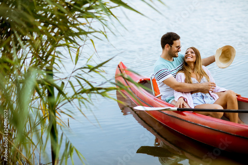 Loving couple rowing on the...