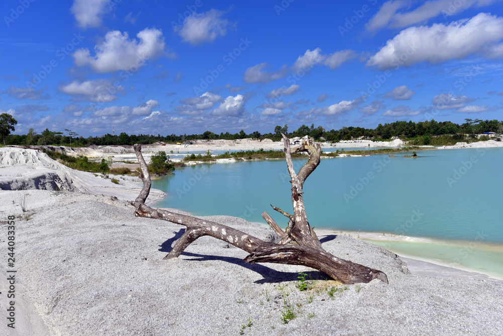 Clear blue lake Kaolin and white land containing kaolinite covered with rain water on Belitung Island, Indonesia