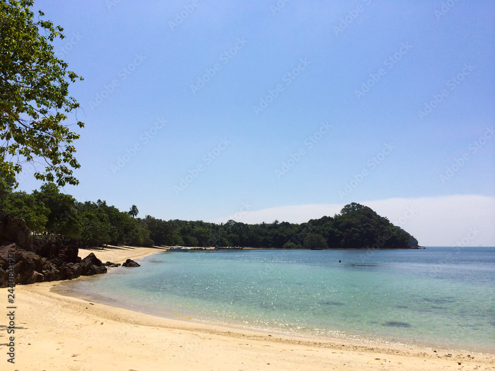Wild tropical sandy beach with rocks