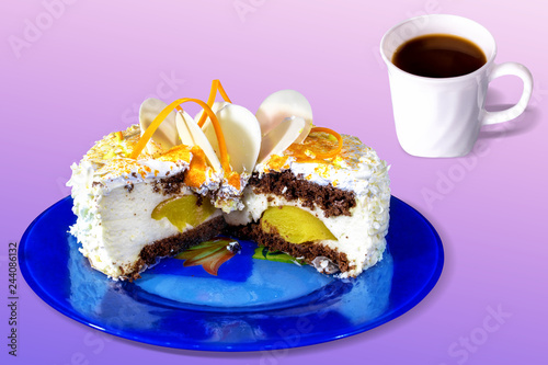 Creamy cake with a piece cut out with clices if oranges on blue plate and cup of tea coffee, isolated. Copy space. photo