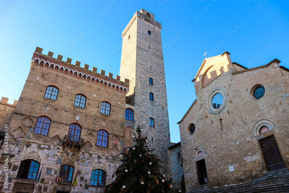 View with Torre Grosso (great tower) and cathedral with christmas tree, medieval town San Gimignano, Tuscany, Italy