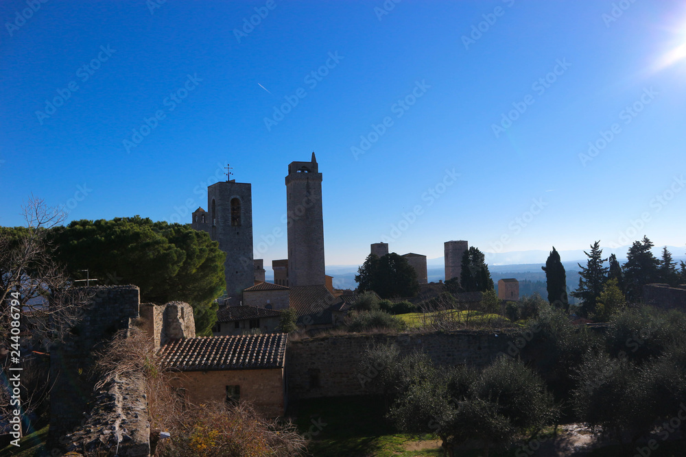 Torre Grossa (big tower) with the tops of other medieval towers of San Gimignano, view from Rocca di Montestaffoli fortress, Tuscany, Italy