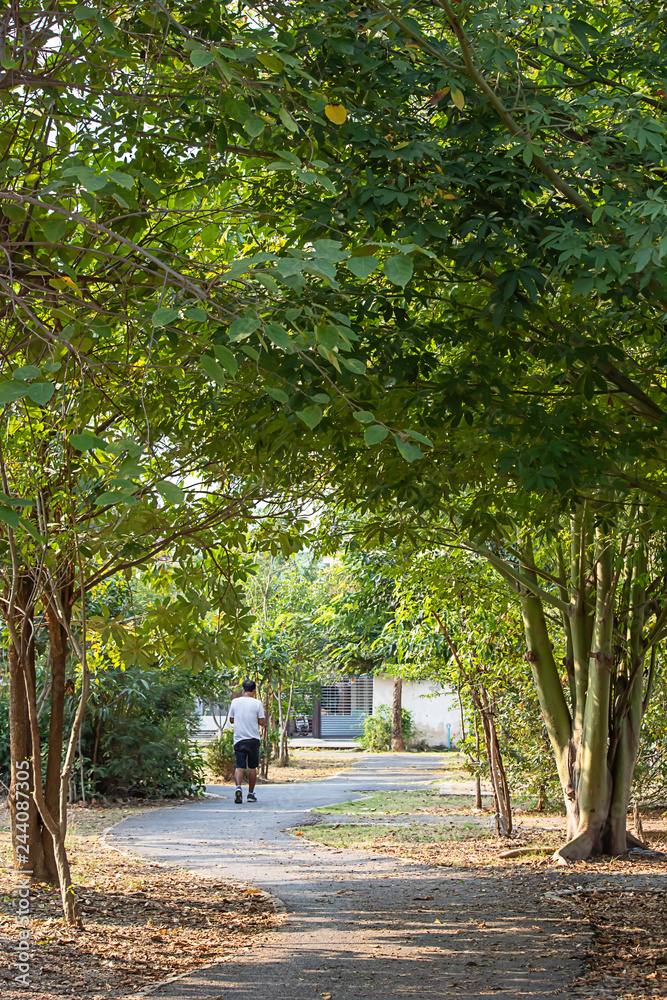 Man running exercise for health in the BangYai park , Nonthaburi in Thailand.