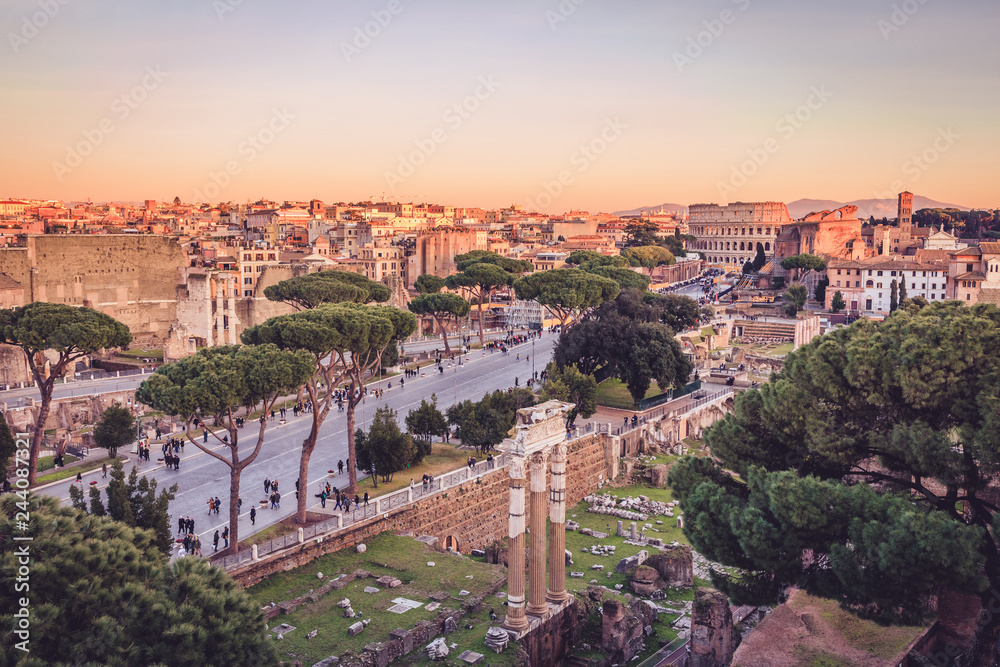 Foro di Cesare and Colosseum in the background in golden hour light