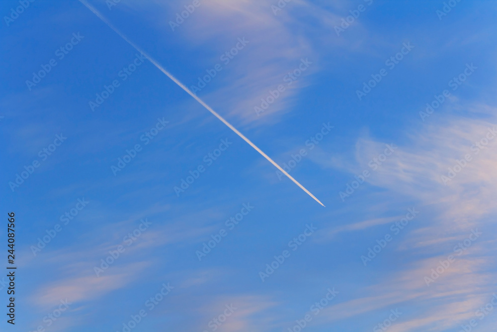 Trail of an airplane in the sky with clouds Trail of an airplane in the sky with clouds