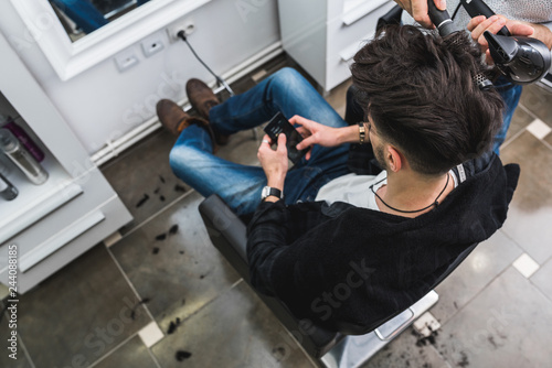 Man having his hair dried in hairdressing salon