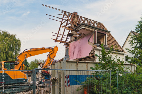 Ruined building and an excavator, germany, hamburg, 20.08.2012