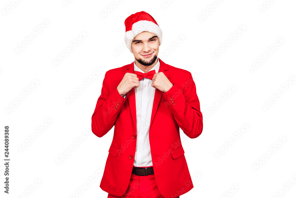 toastmaster of the Christmas event. stylish bearded man in a red suit with a Santa hat toastmaster of the Christmas event. stylish bearded man in a red suit with a Santa hat