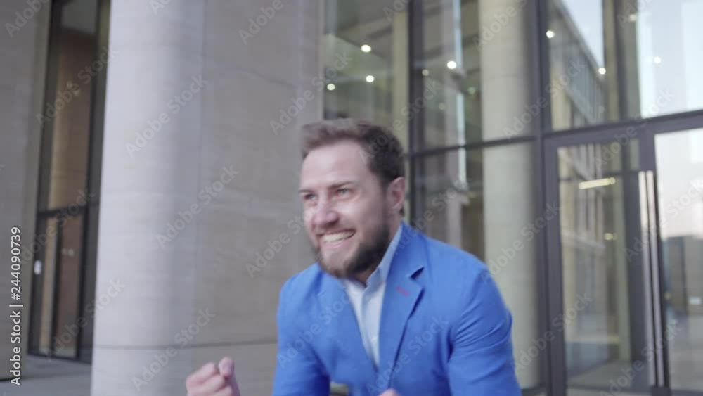 Happy businessman leaving business center and celebrating success emotionally after productive meeting with partners Happy businessman leaving business center and celebrating success emotionally after productive meeting with partners