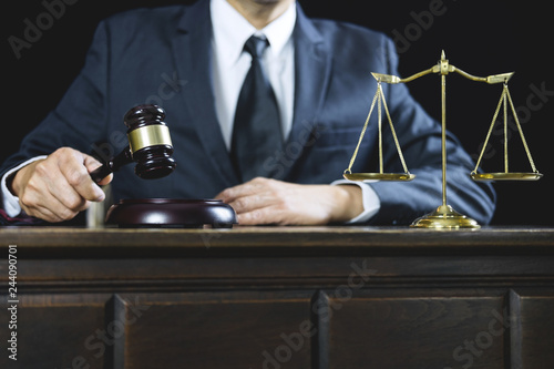 Counselor or Male lawyer working on courtroom sitting at the table. Legal law  Judge gavel with Justice lawyers advice with gavel and Scales of justice