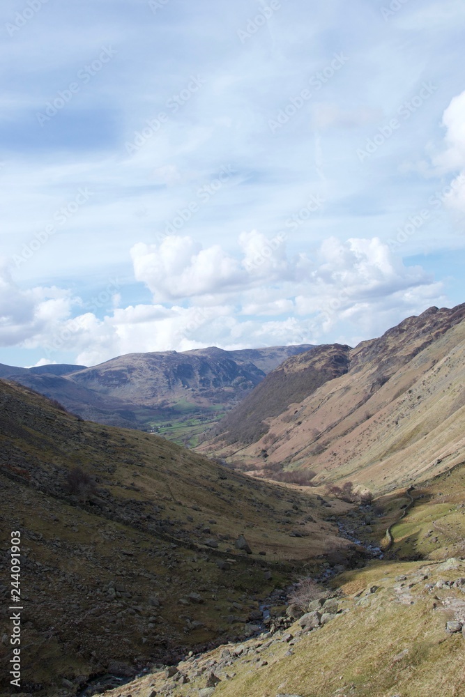 Valley in Lake District (Cumbria, UK); green farmland in distance Valley in Lake District (Cumbria, UK); green farmland in distance