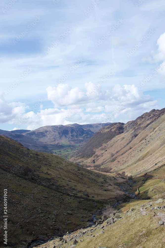 Valley in Lake District (Cumbria, UK); green farmland in distance