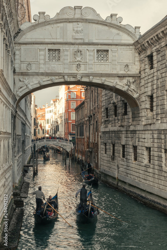 Gondolas floats in the canal under beautiful Ponte dei Sospiri in Venice, Italy © Gioia