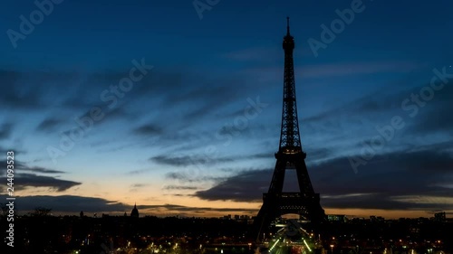 Night to Day timelapse of Eiffel tower in winter from Trocadero on a cloudy day - Paris, France.