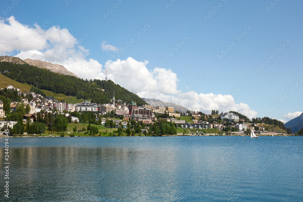 Sankt Moritz town, lake and sail boat in a sunny summer day in Switzerland
