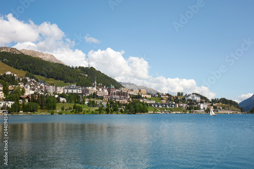 Sankt Moritz town, lake and sail boat in a sunny summer day in Switzerland