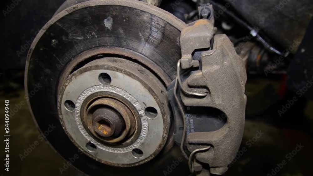car repair. Auto mechanic changes the pads on the disc, ventilated brakes.
