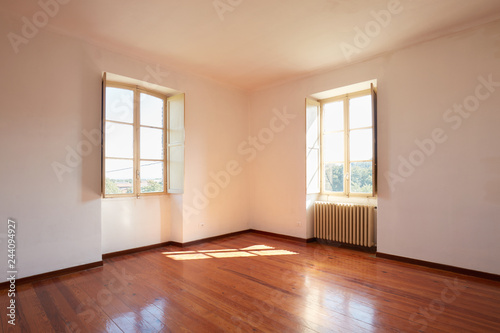 Old room with wooden floor in a country house  sunlight