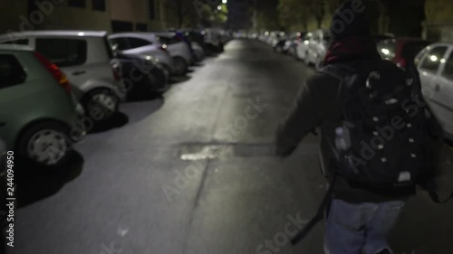 A young man runs on an empty street in Rome's suburbs