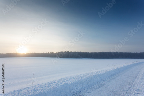 Winter landscape at sunrise with road © wolf139