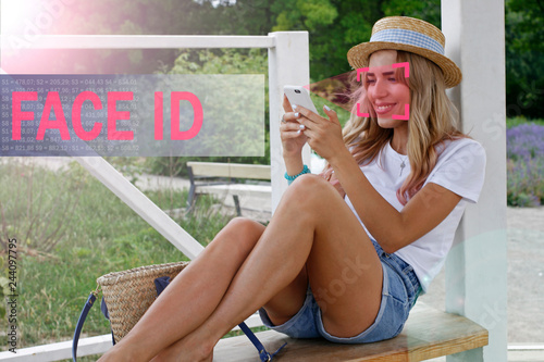 Face recognition. Biometric verification. The concept of new face recognition technology. Young modern girl. Young girl with a phone in her hands