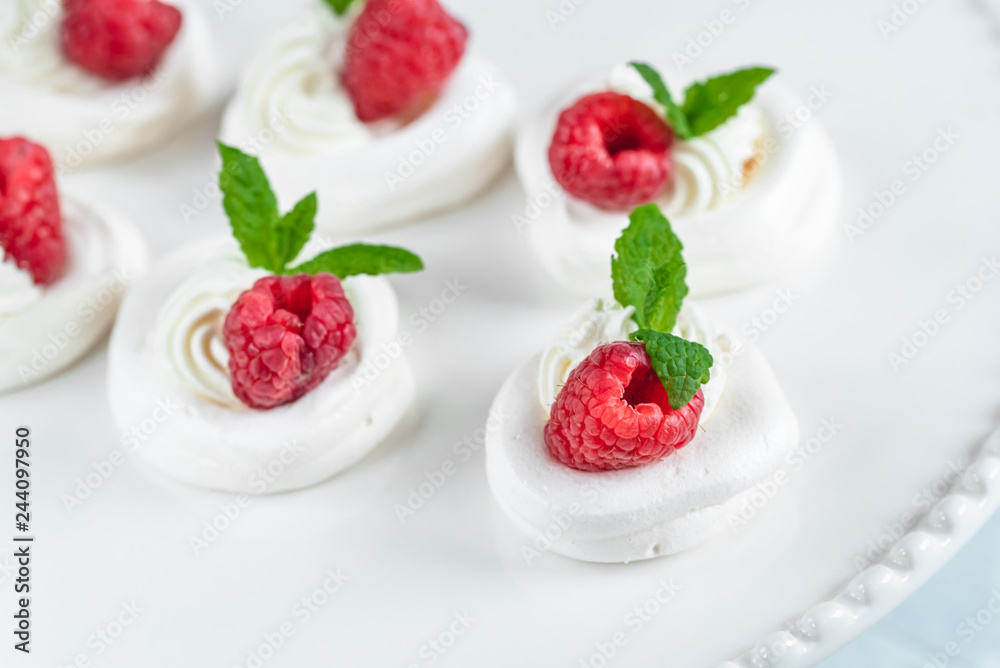 Mini Pavlova meringue with whipped cream and raspberries. Mini Pavlova meringue with whipped cream and raspberries.