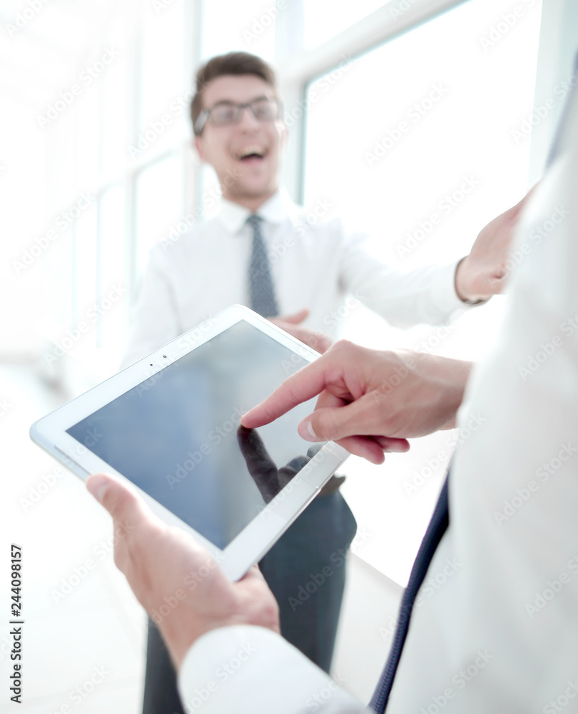 close up.employees discuss standing in the hallway of the office close up.employees discuss standing in the hallway of the office