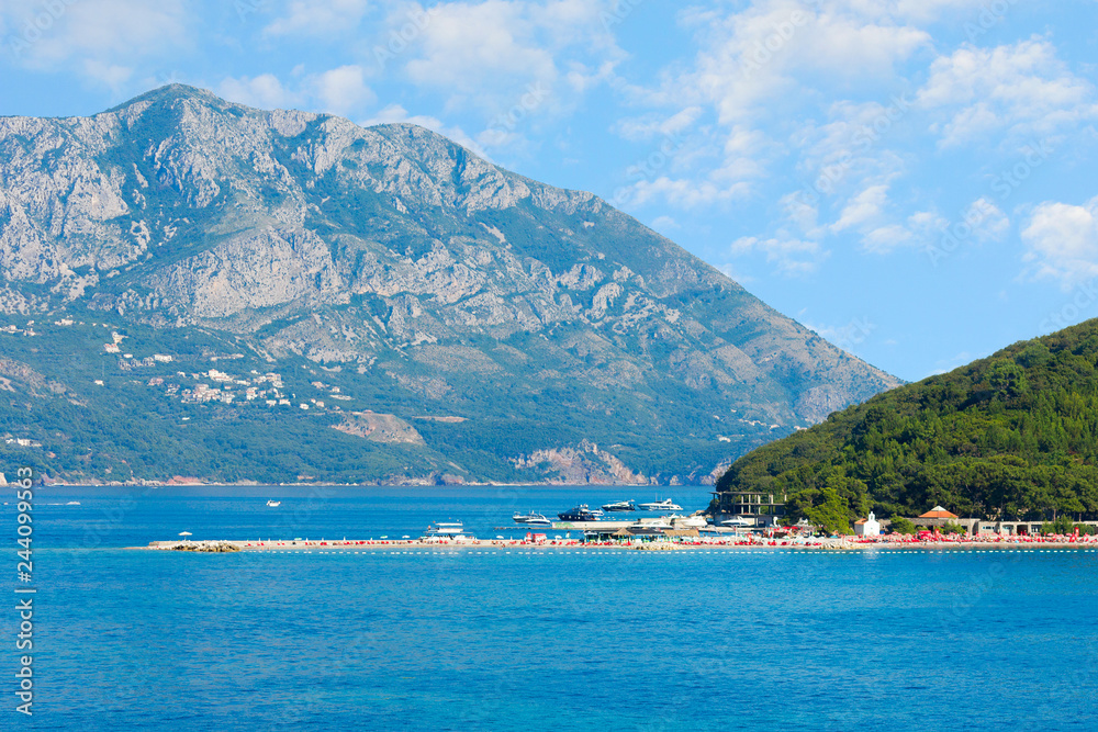 St. Nicholas island near Budva in Montenegro. Coast with blue sea, rocks and sky with clouds St. Nicholas island near Budva in Montenegro. Coast with blue sea, rocks and sky with clouds