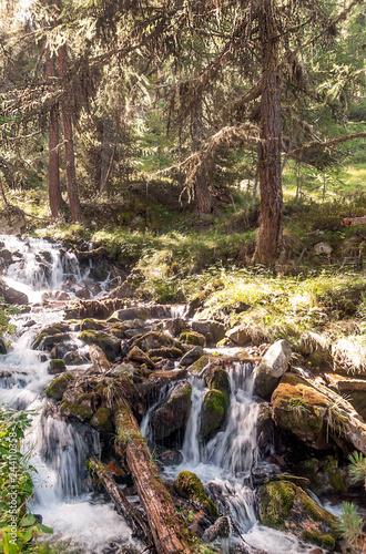 River in the mountains of the Swiss Alps in the Saint Luc valley on a sunny day.