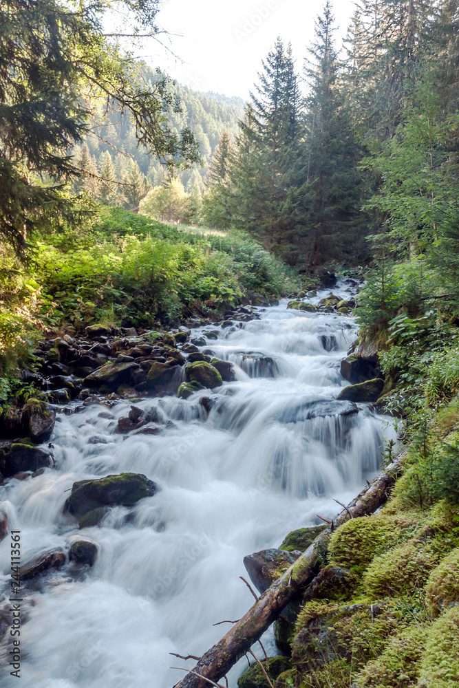 River in the mountains of the Swiss Alps in the Saint Luc valley on a sunny day. River in the mountains of the Swiss Alps in the Saint Luc valley on a sunny day.