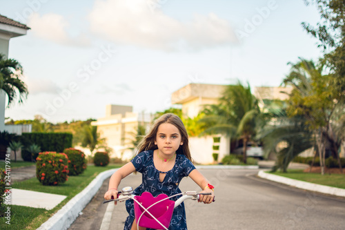 Criança brinca bicicleta correndo photo