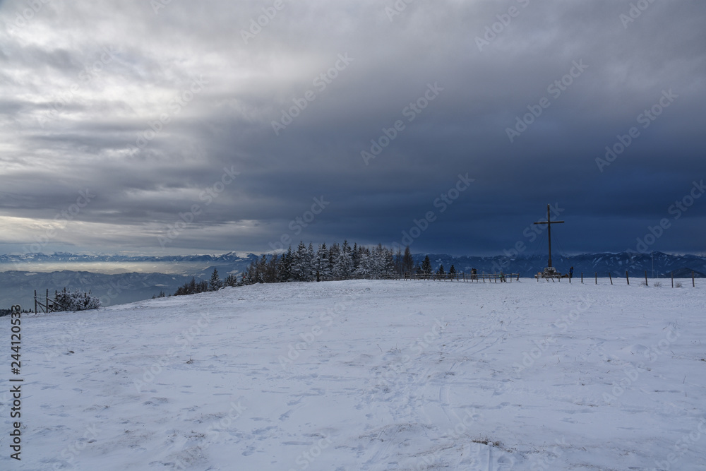 Summit cross on mountain Schockl in winter, Austria