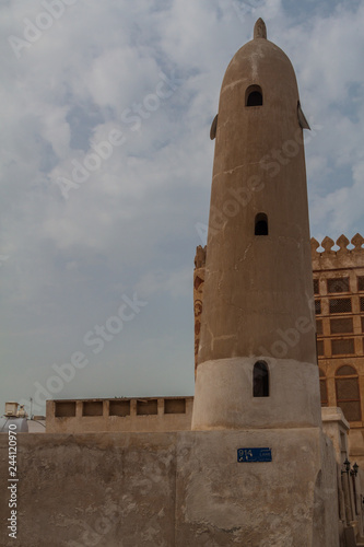 Minaret of the Siyadi mosque and the Siyadi house behind it.  Muharraq, Bahrain.