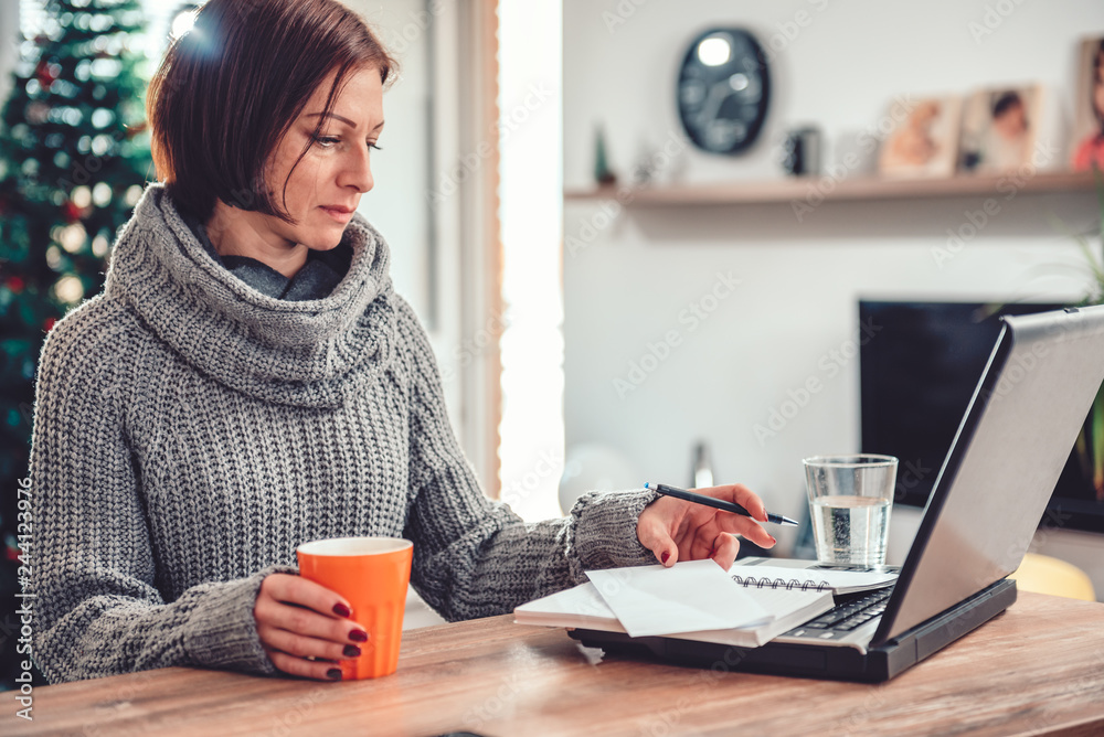 Woman working in home office and drinking coffee Woman working in home office and drinking coffee