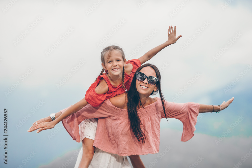 Beautiful happy family in mountains in the background of fog. Beautful landscape Beautiful happy family in mountains in the background of fog. Beautful landscape