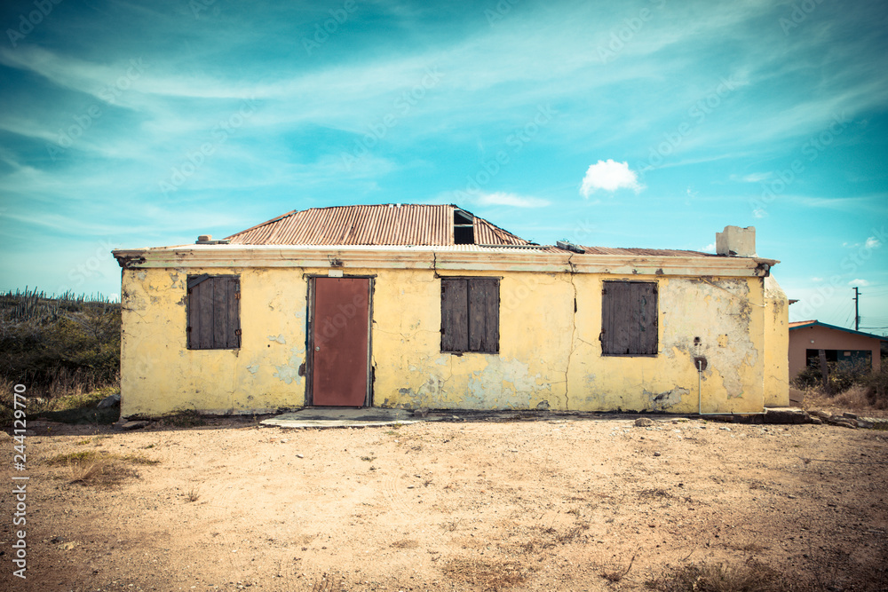 Weathered abandoned building with peeling yellow paint