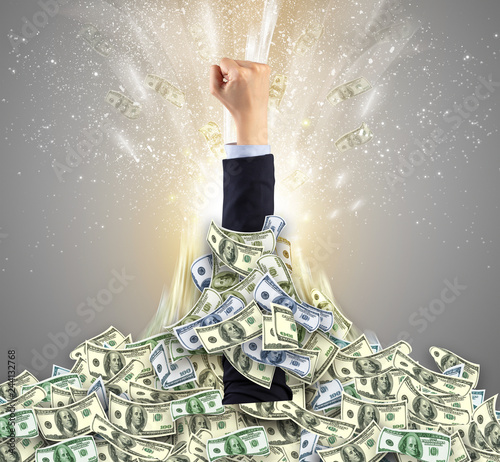 Fényképezés Hand bursting from a huge money pile