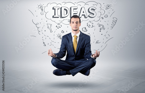 Businessman sitting in yoga position and meditates with doodle concept 