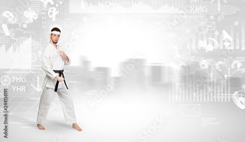 Young karate trainer doing karate tricks on the top of a metropolitan city  © ra2 studio