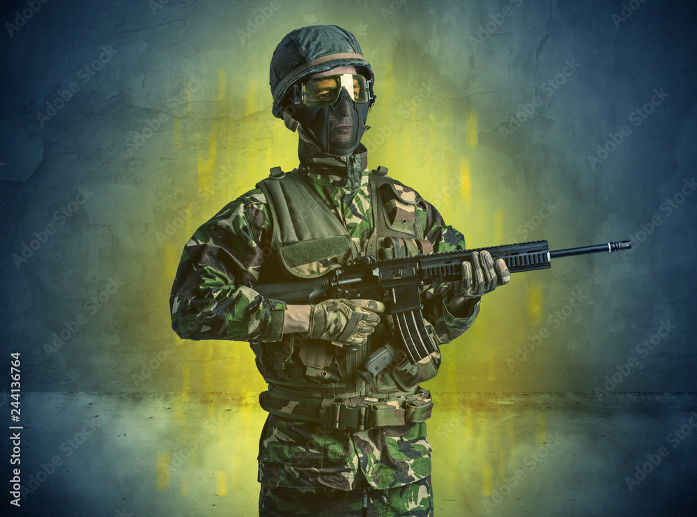 Naklejka premium Hazard, groźny żołnierz w zrujnowanym, kruchym budynku z bronią w dłoni