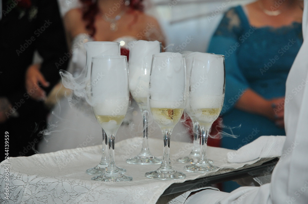 Waitress holding a dish of champagne and wine glasses at some festive event, Waitress holding a dish of champagne and wine glasses at some festive event,