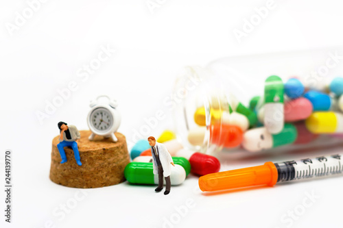 Miniature people: Patients sitting with drugs and clock. Health care and business concept.
