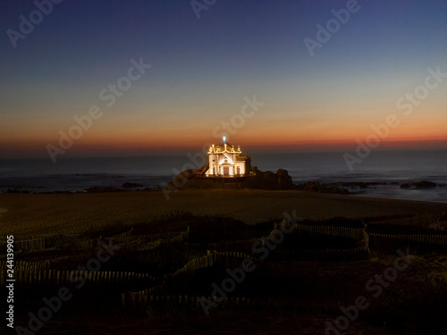 Landscape over the beach of miramar with view to chapel of senhor da Pedra at blue hour © Aldrin