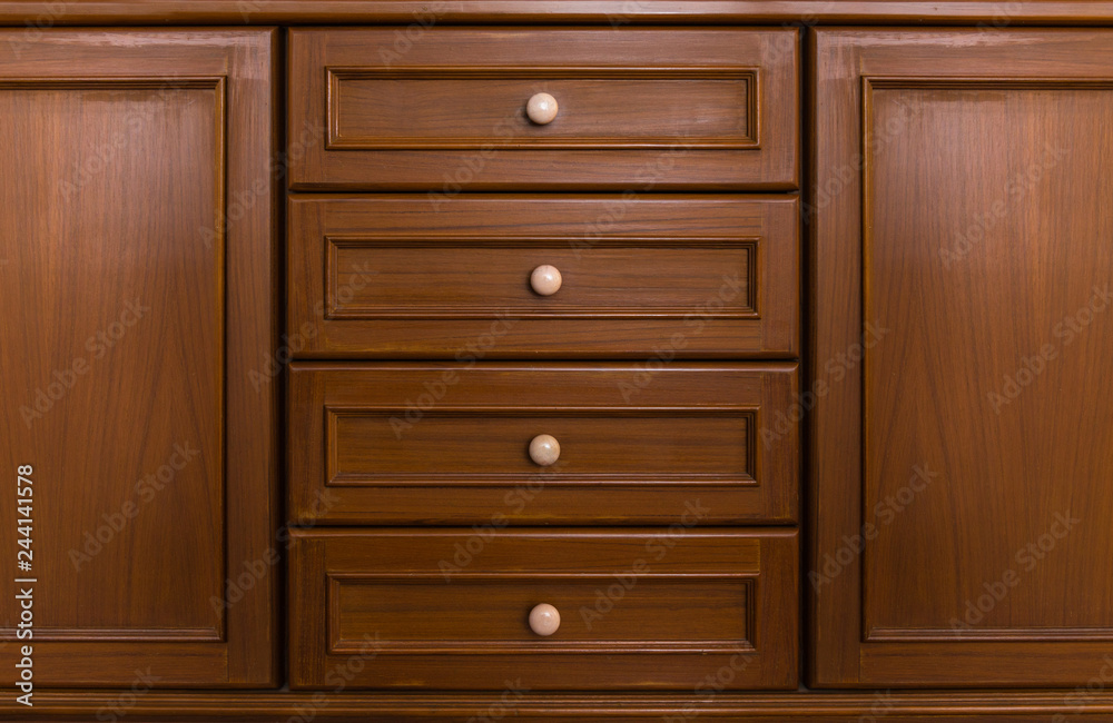 Front showcase cabinet or wardrobe wooden frame door and drawers made from dark wood, background and texture. Front showcase cabinet or wardrobe wooden frame door and drawers made from dark wood, background and texture.