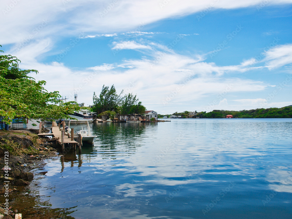 Fototapeta premium Harbor view with calm water and cloudy sky