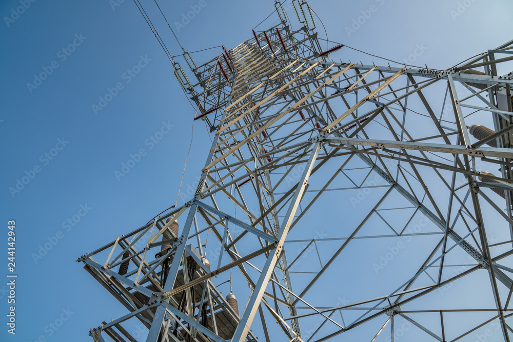high voltage tower on background of blue sky