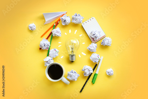 Flat lay brainstorming table top with light bulb icon view photo