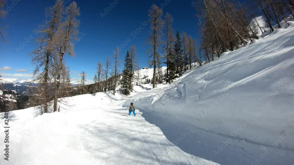 Little boy skiing. A 5 year old child enjoys a winter holiday in the Alpine resort. Stabilized footage. Slow motion. Little boy skiing. A 5 year old child enjoys a winter holiday in the Alpine resort. Stabilized footage. Slow motion.